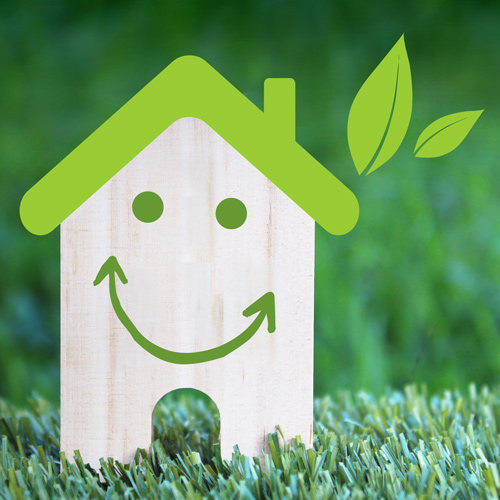 green energy home graphic smiling house and green leaves